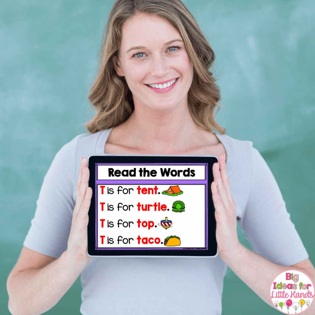 This image shows a teacher holding an iPad with digital letter of the week activities displayed on the iPad. 